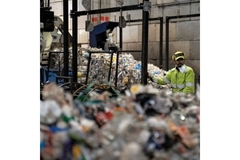 Image Man working in recycling facility.